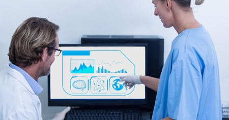Surgeon pointing towards desktop pc at the hospital