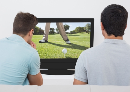 Rear view of friends watching golf on television at home
