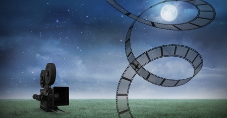 Digital generated image of film reel against video camera and night sky in backgroundの写真素材