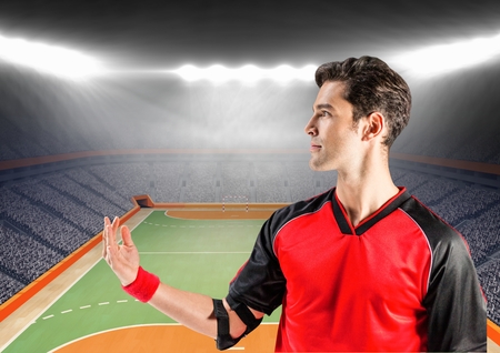 Digital composition of handball player in stadium