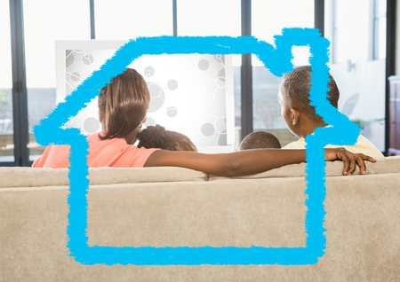 Rear-view of family sitting on sofa at home against home outline in backgroundの写真素材