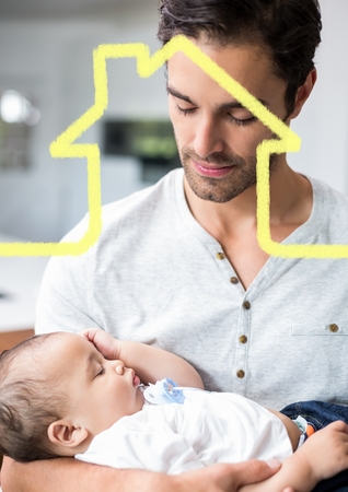 Digital composition of man holding baby overlaid with house shapeの写真素材