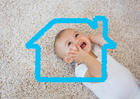 Digital composition of home outline with smiling baby in backgroundの写真素材