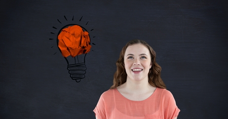 Digital composite image of woman smiling against crumpled paper forming light bulb