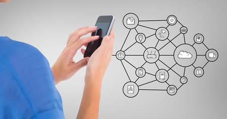 Woman using smart phone with digitally generated iconsの写真素材