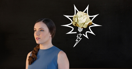 Digital generated image of thoughtful female executive standing against black backgroundの写真素材