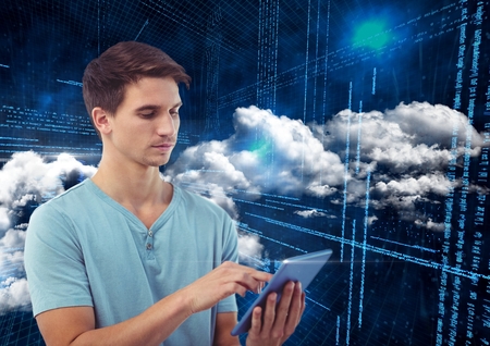 Man using digital tablet against digitally generated backgroundの写真素材