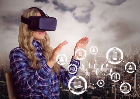 Woman using virtual reality headset with digitally generated icons against cityscape in background
