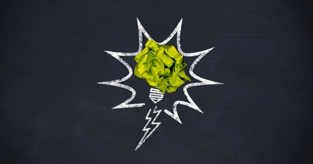 Digital composition of crumpled paper on light bulb shape against black backgroundの写真素材