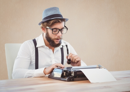 Retro style man holding smoking pipe and using a typewriter at desk