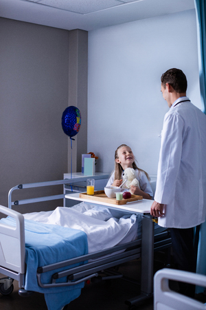 Doctor interacting with patient in hospitalの写真素材