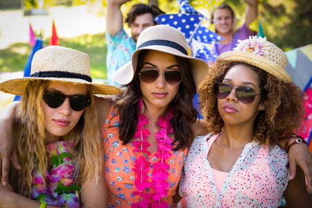 Portrait of friends standing together in park on a sunny dayの写真素材