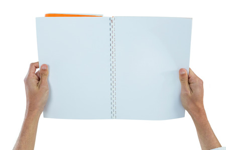 Hands holding a blank book against white background