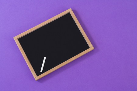 Slate with chalk on purple backgroundの写真素材