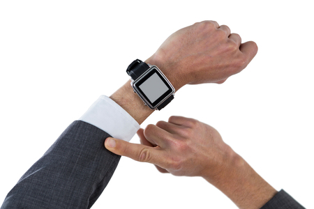 Hand of businessman wearing smart watch against white backgroundの写真素材