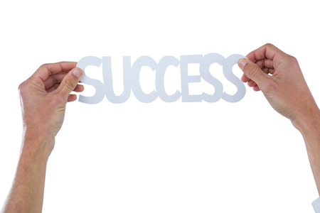 Hand holding success word against white backgroundの写真素材