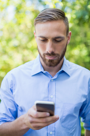 Man using mobile phone in a parkの写真素材