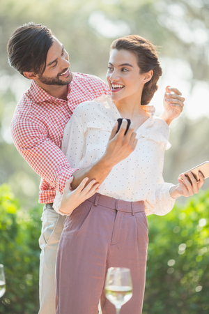 Man proposing a woman with a ring in the restaurantの写真素材