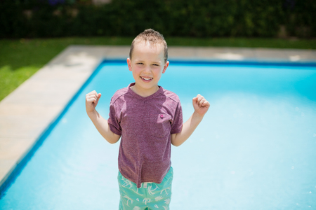 Portrait of smiling girl standing near swimming poolの写真素材