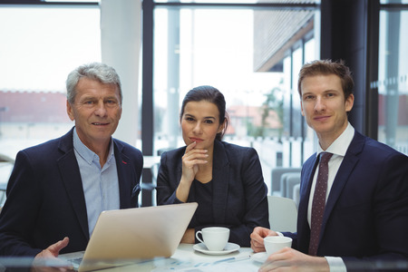 Portrait of smiling businesspeople in officeの写真素材