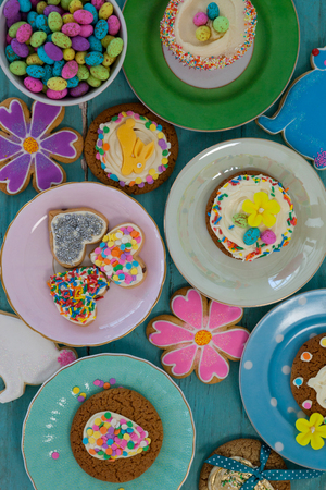 Various sweet foods served in plates on wooden surface