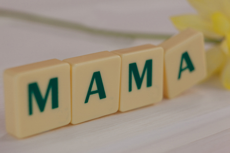 Close-up of blocks displaying mama message on wooden surfaceの写真素材