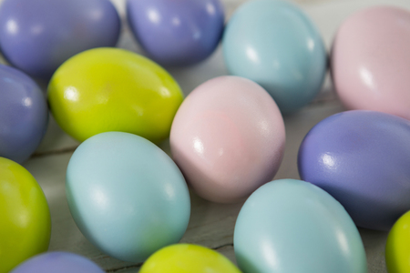 Close-up of multicolored Easter eggs on wooden surfaceの写真素材