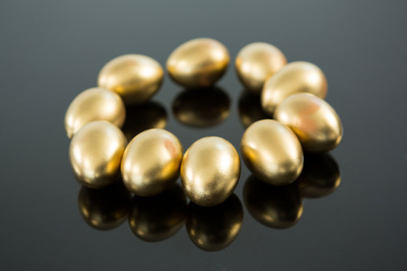 Close-up of golden Easter eggs on black backgroundの写真素材