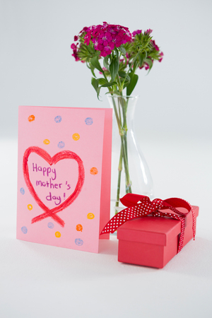 Happy mothers day greetings with gift box and flower vase on white backgroundの写真素材