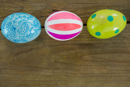 Multicolored Easter eggs on wooden surfaceの写真素材