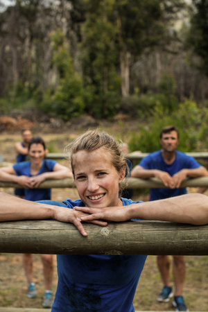 People leaning on hurdles during obstacle training in boot campの写真素材
