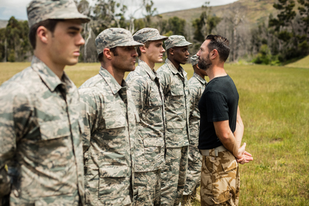 Trainer giving training to military soldier at boot campの写真素材