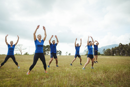 Fit people performing stretching exercise in bootcampの写真素材