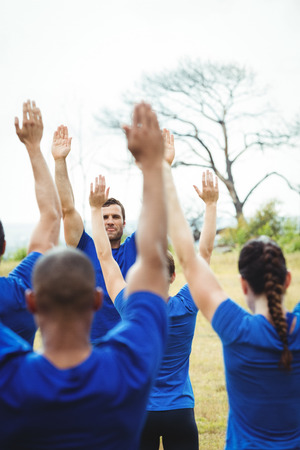 Fit people performing stretching exercise in bootcampの写真素材