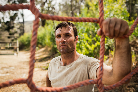 Military soldier standing near fitness trial at boot camp