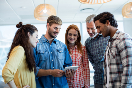 Creative business team using digital tablet in officeの写真素材