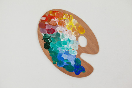 Paint palette with multiple colors against white backgroundの写真素材