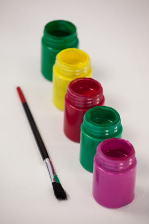 Watercolor paints and paint brush against white backgroundの写真素材