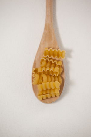 Riccioli in wooden spoon on white backgroundの写真素材