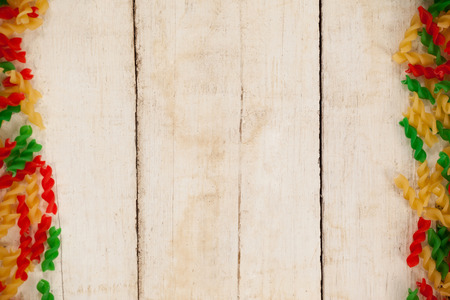 Close-up of tri-colored rotini pasta on wooden backgroundの写真素材