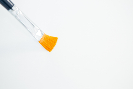 Close-up of flat paintbrush on white backgroundの写真素材