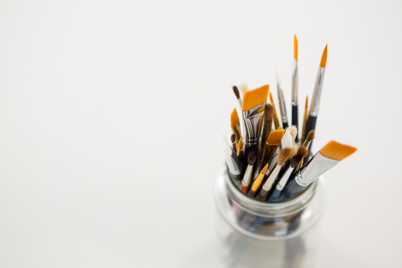 Various paintbrush in a jar on white backgroundの写真素材