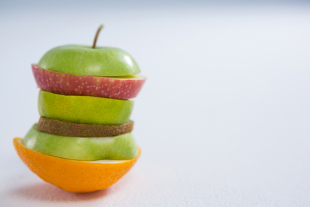 Stack of various fruits slices against white backgroundの写真素材