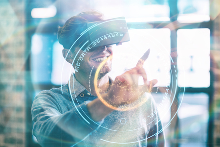 Digital image of globe with big data text against businessman using virtual reality headset in...