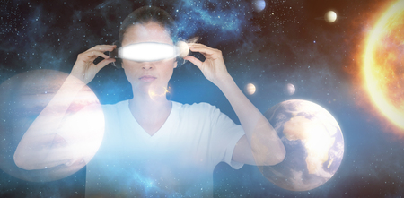 Young woman with virtual video glasses against composite image of solar system against white...