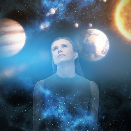 Sad woman looking up against graphic image of various planets with sun 3dの写真素材