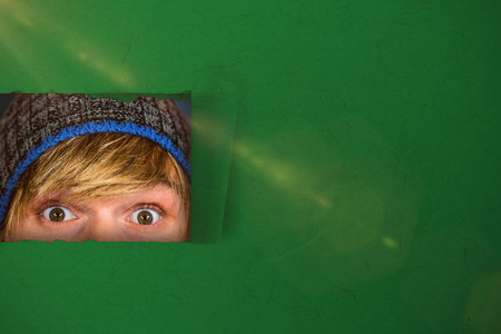 Close up of half face of hipster man  against blue background with vignette 3dの写真素材