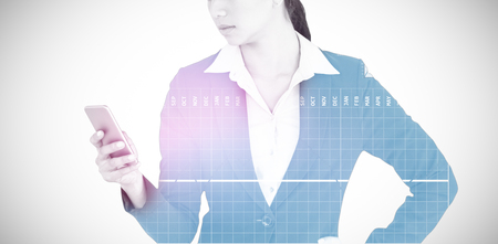 Businesswoman using mobile phone against grey background 3dの写真素材