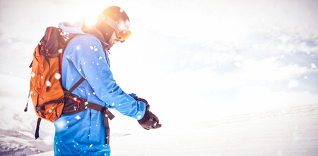 Skier wearing hand gloves while getting ready for skiingの写真素材