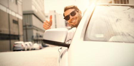 Happy businessman with thumbs up while driving carの写真素材